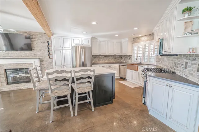 a kitchen with stainless steel appliances granite countertop a sink and a white cabinets