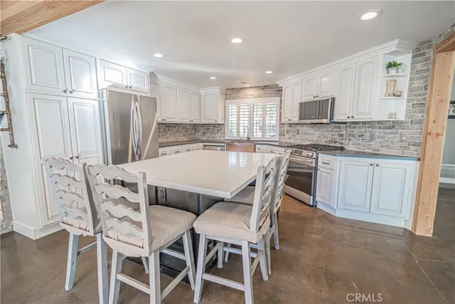 a bathroom with a sink toilet and window