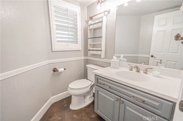 a kitchen with a sink a stove cabinets and wooden floor