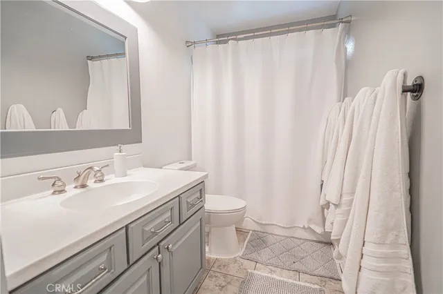 a large bed sitting in a bedroom next to a window