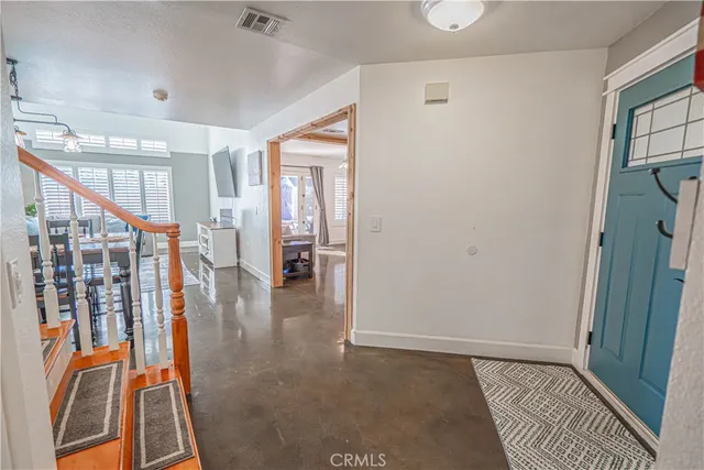 a view of a livingroom with furniture and stairs