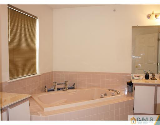 34 Inverness Drive Edison, NJ 08820 - Photo 11 of 16 a bathroom with a bathtub and a sink