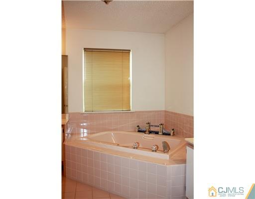 34 Inverness Drive Edison, NJ 08820 - Photo 12 of 16 a bathroom with a tub and a sink