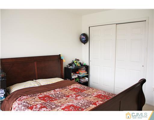 34 Inverness Drive Edison, NJ 08820 - Photo 15 of 16 a bedroom with a bed and a dresser
