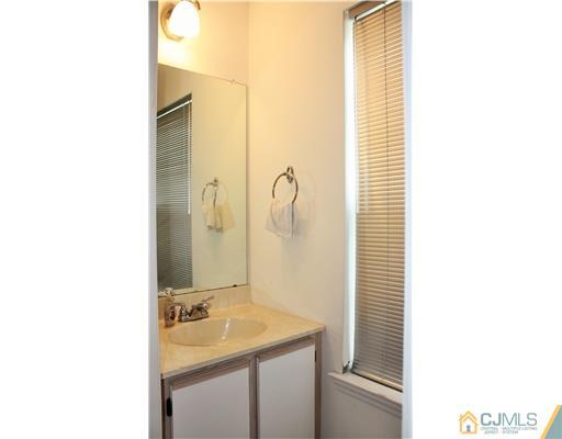 34 Inverness Drive Edison, NJ 08820 - Photo 8 of 16 a bathroom with a sink and a mirror