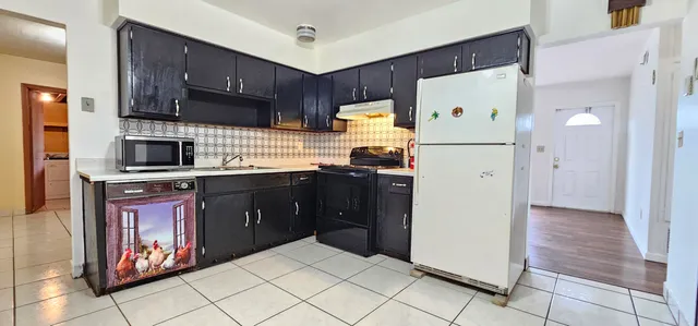 a kitchen with stainless steel appliances a refrigerator and a stove