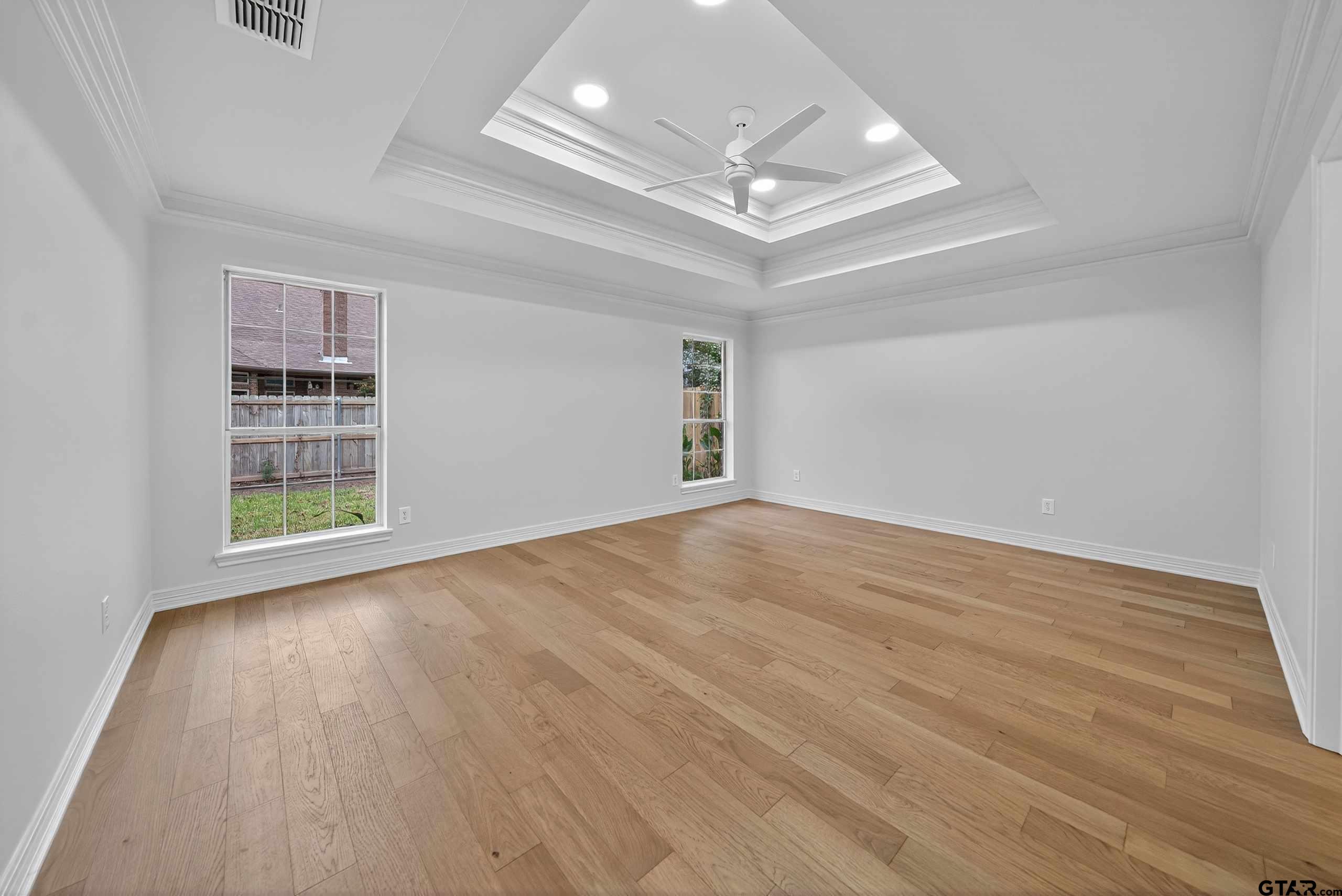 3409 Pebblebrook Drive Tyler, TX 75707 - Photo 18 of 48 wooden floor in an empty room with a window