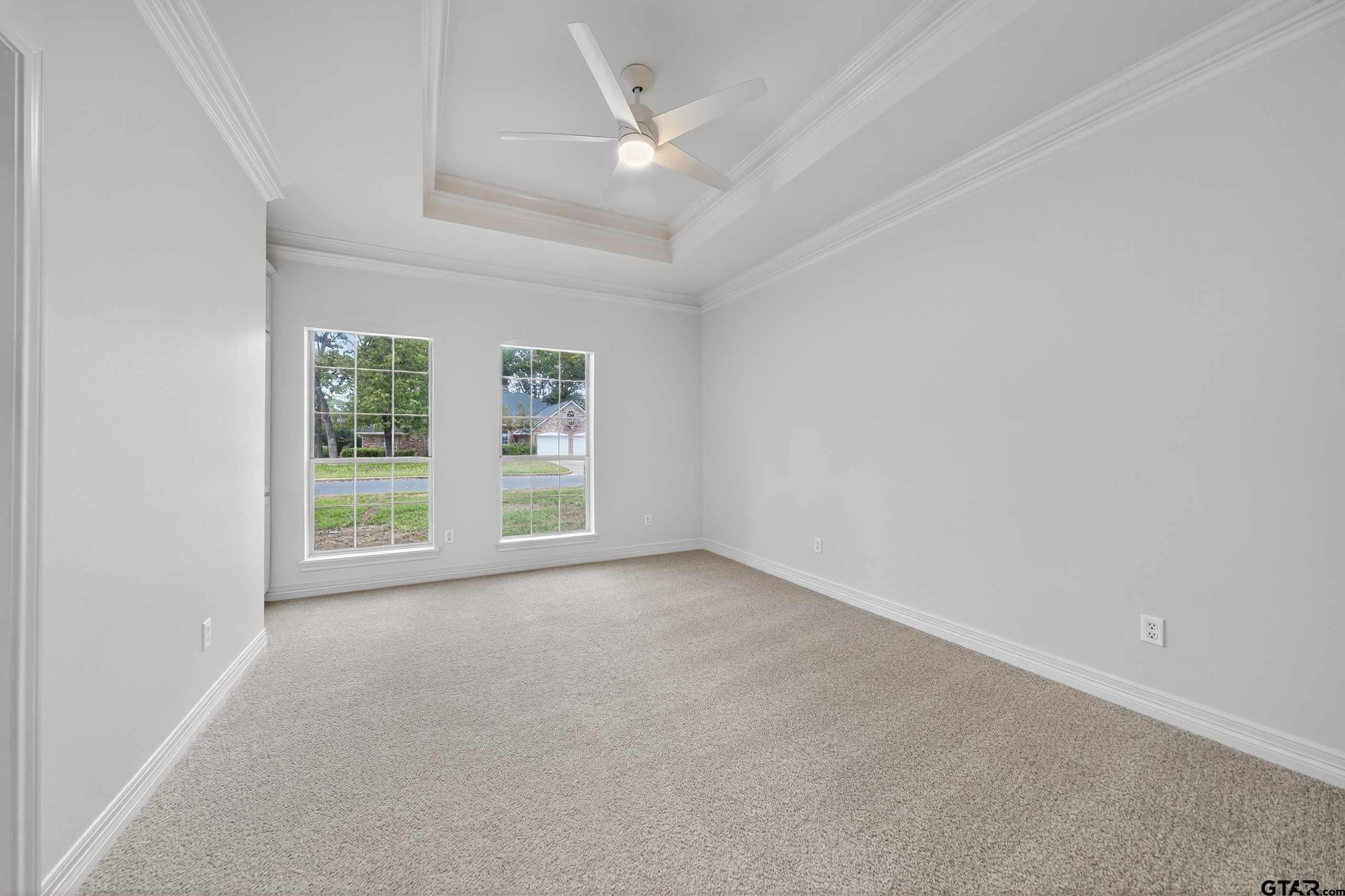3409 Pebblebrook Drive Tyler, TX 75707 - Photo 27 of 48 an empty room with windows and ceiling fan