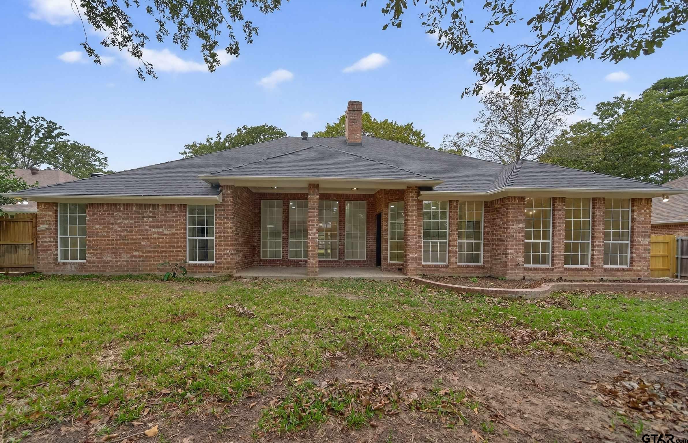 3409 Pebblebrook Drive Tyler, TX 75707 - Photo 48 of 48 a front view of a house with a garden