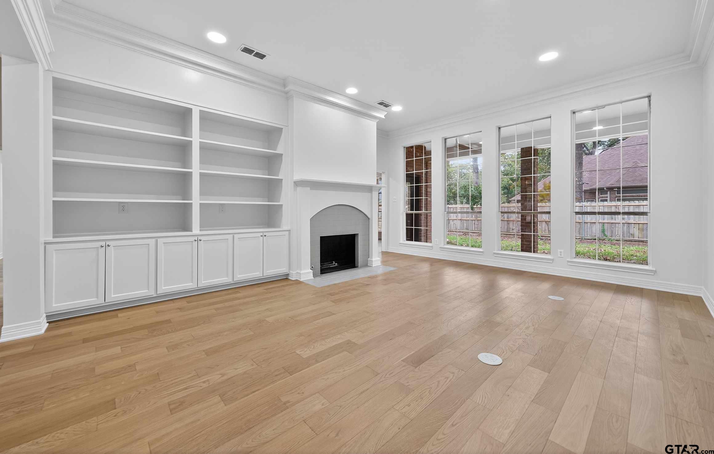 3409 Pebblebrook Drive Tyler, TX 75707 - Photo 8 of 48 a view of an empty room with a fireplace and a window