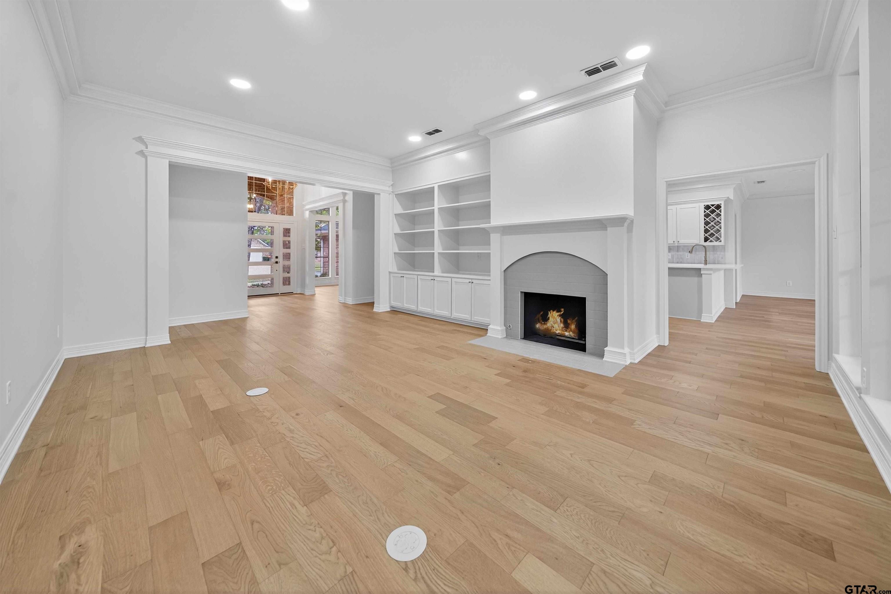 3409 Pebblebrook Drive Tyler, TX 75707 - Photo 9 of 48 a view of an empty room with a fireplace and a window
