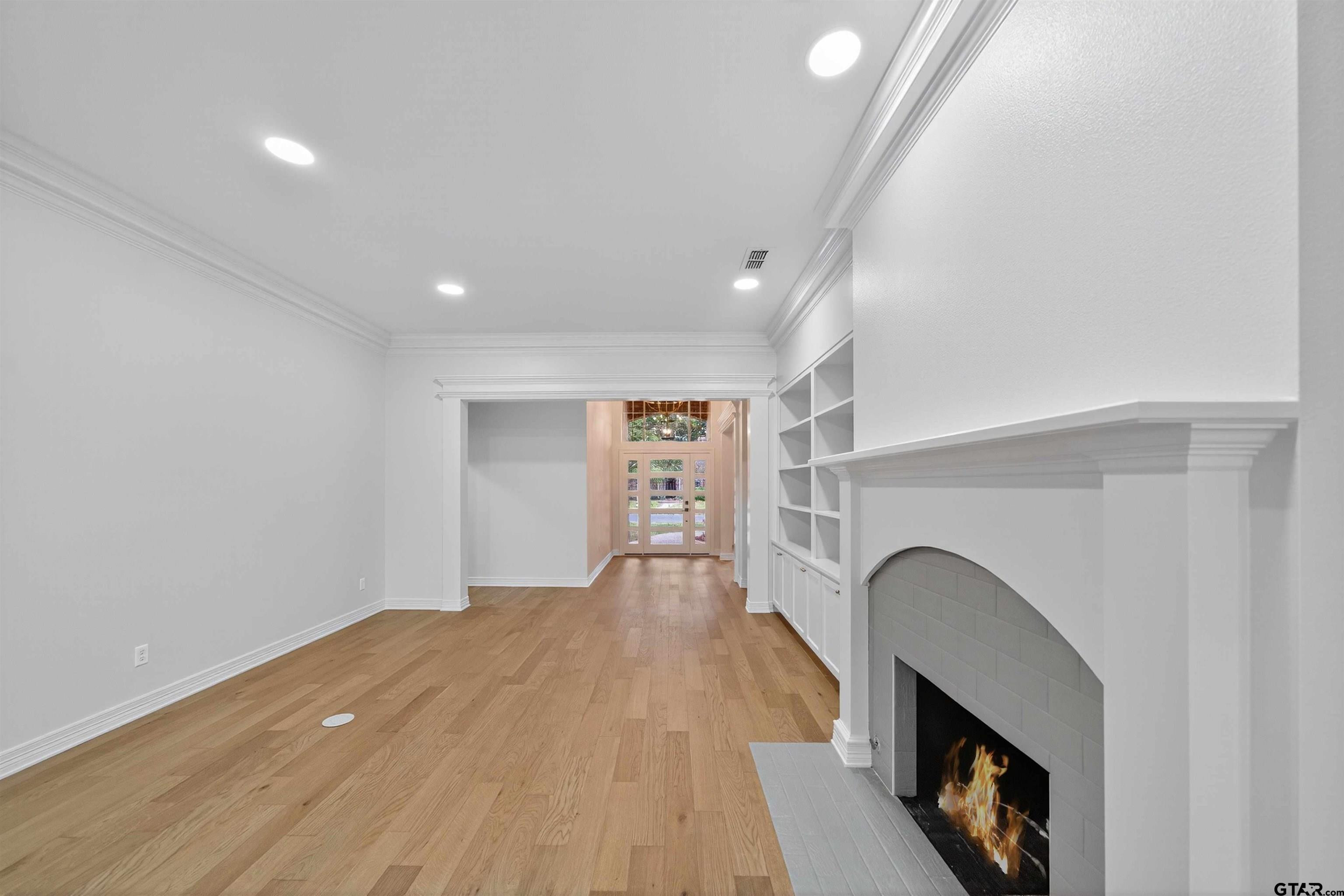 3409 Pebblebrook Drive Tyler, TX 75707 - Photo 10 of 48 a view of empty room with wooden floor and fireplace