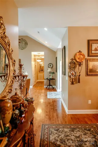 a bedroom with a bed and dresser with mirror