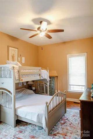 a bathroom with a granite countertop bathtub shower sink vanity and toilet