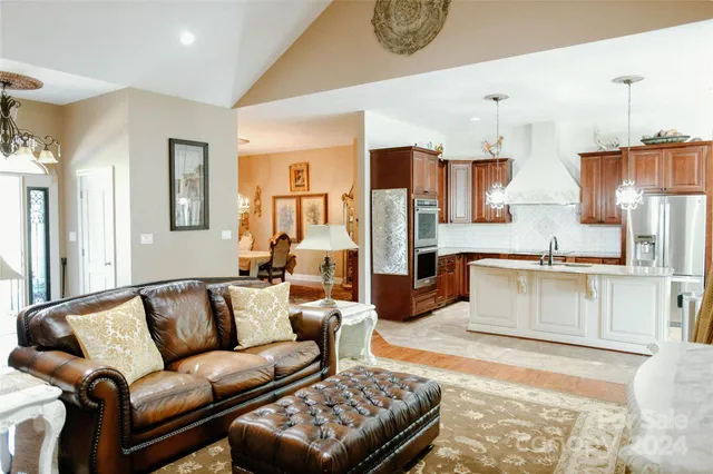 a kitchen with stainless steel appliances granite countertop a sink a refrigerator and a granite counter tops