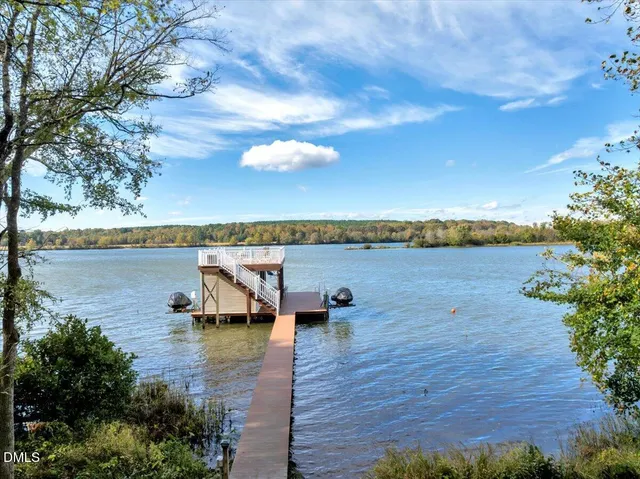 a kitchen with a dining table chairs and refrigerator