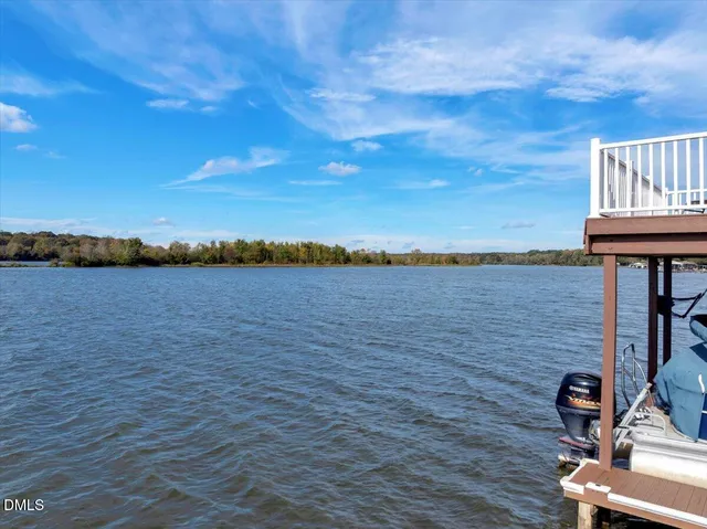 a kitchen with stainless steel appliances granite countertop a sink a stove a refrigerator cabinets and a kitchen island