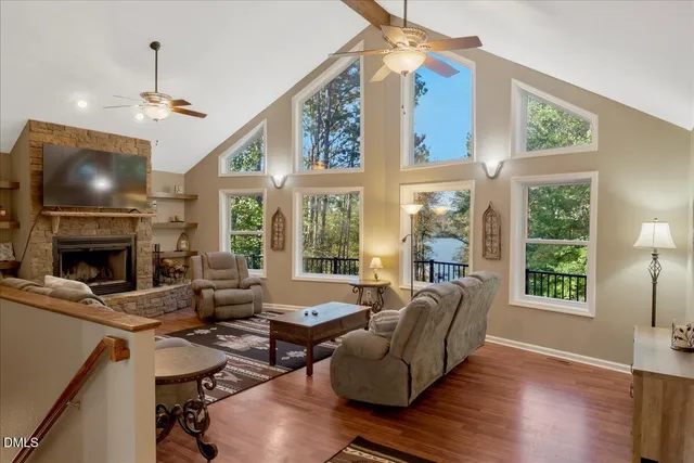 a view of a deck with a floor to ceiling window and wooden fence