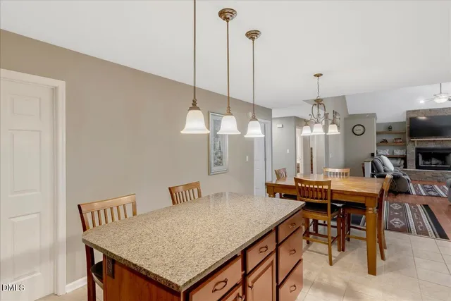 a view of a chairs and table in a back yard