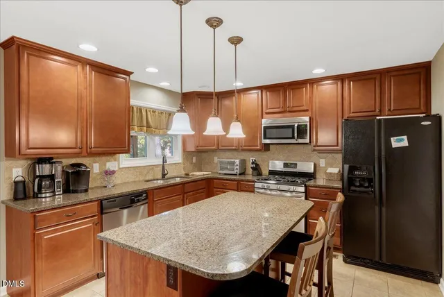a kitchen with a table and chairs in it