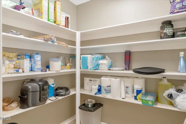 a bedroom with furniture and a flat screen tv