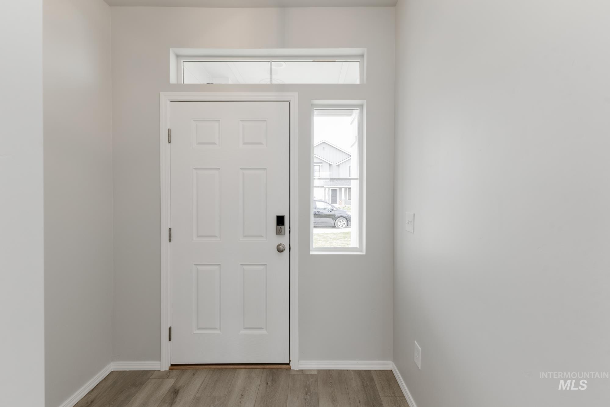 12842 Ropers Street Nampa, ID 83651 - Photo 2 of 29 Entryway featuring a six-panel door, transom window, and a sidelight window