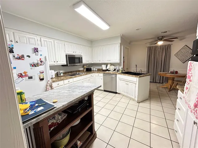 a kitchen with stainless steel appliances a stove a sink and a refrigerator