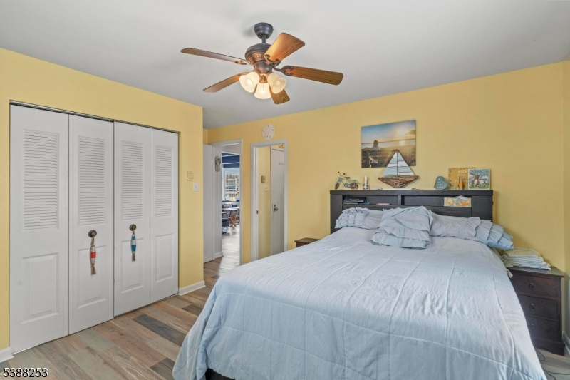 112 Curlew Road Tuckerton, NJ 08087 - Photo 14 of 20 a bedroom with a bed and a chandelier