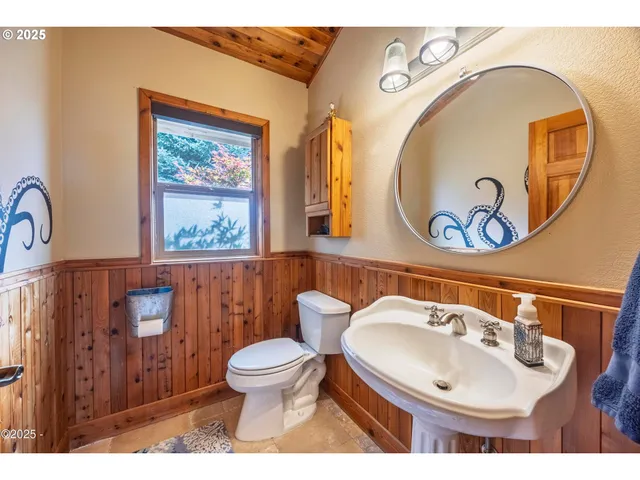 a bathroom with a toilet a sink and a mirror