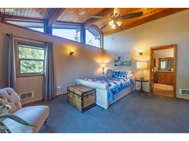 a bedroom with a bed couch and window