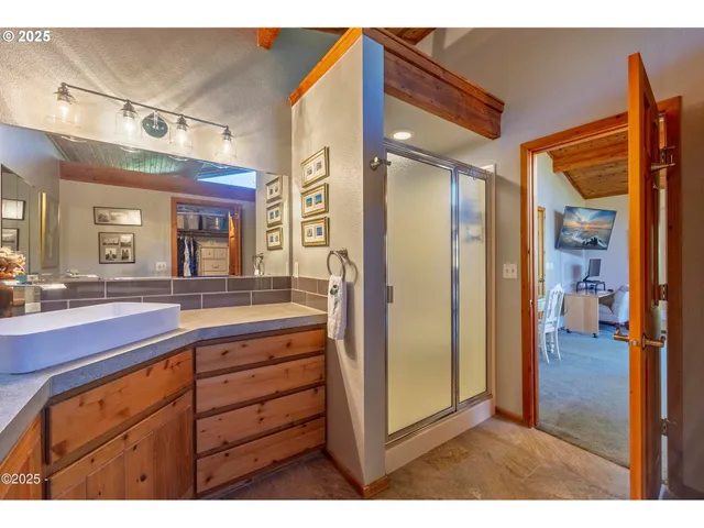 a bathroom with a sink a mirror and a shower