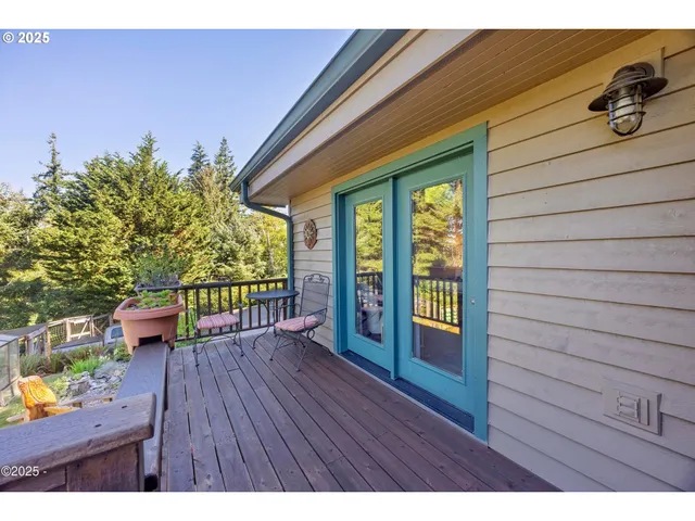 a view of a table and chairs in backyard of the house
