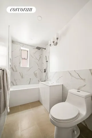 a bedroom with two beds and a window