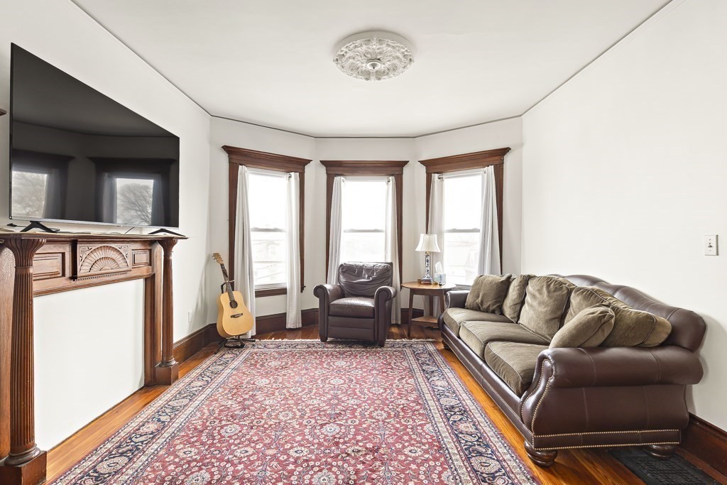 55 Main Street Somerville, MA 02145 - Photo 8 of 28 a living room with furniture and a rug
