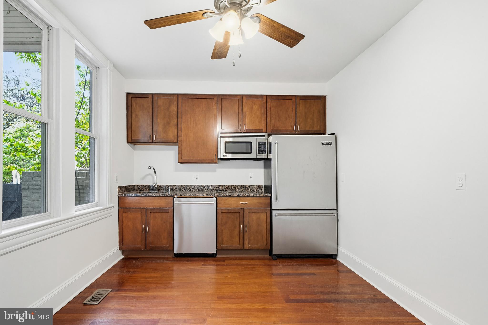 400 7th Street Southeast Washington, DC 20003 - Photo 11 of 23 a kitchen with granite countertop a refrigerator a sink dishwasher a stove top oven a refrigerator and cabinets