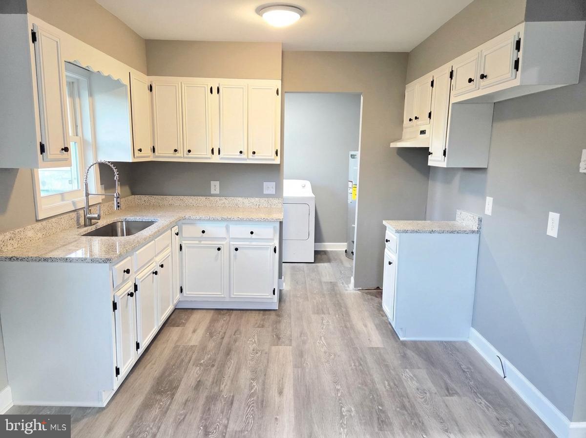 105 Goodwill Avenue Secretary, MD 21664 - Photo 5 of 22 a kitchen with cabinets a sink and a stove top oven