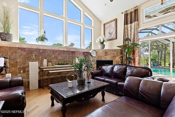 a dining room filled with furniture and a potted plant
