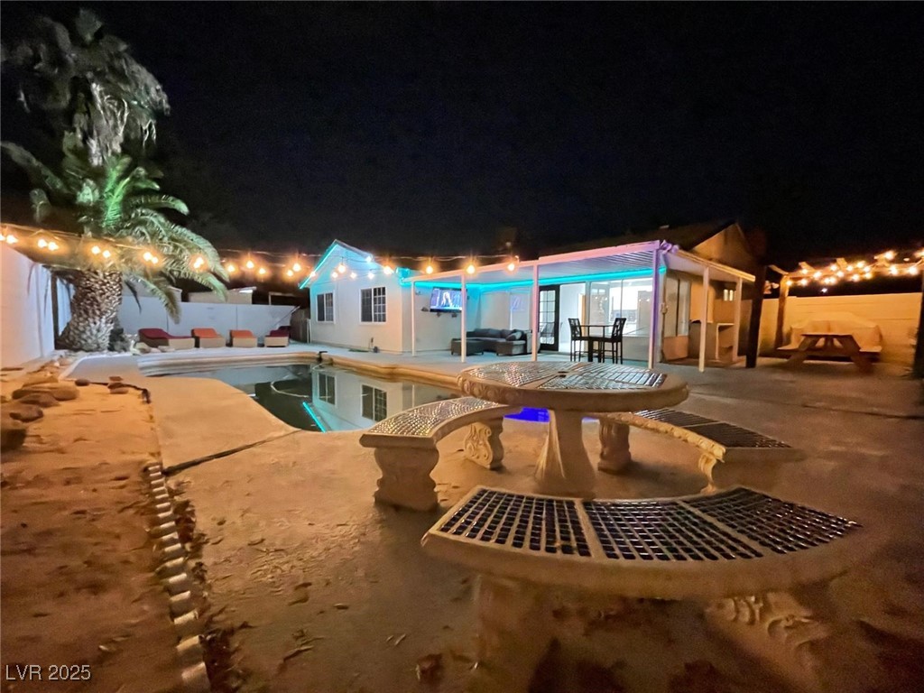 5415 Oxbow Street Las Vegas, NV 89119 - Photo 14 of 20 Pool at twilight featuring a patio and a fenced backyard