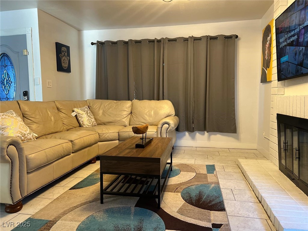 5415 Oxbow Street Las Vegas, NV 89119 - Photo 3 of 20 Living room featuring a fireplace