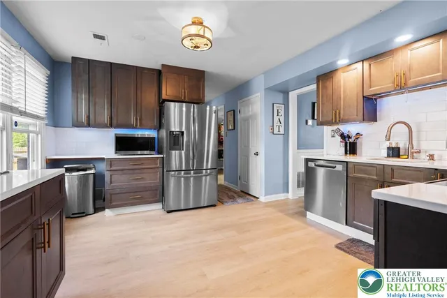 a kitchen with granite countertop a refrigerator and a sink