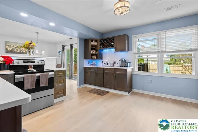 a kitchen with stainless steel appliances granite countertop a stove and a sink