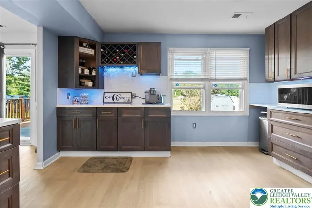 a kitchen with stainless steel appliances granite countertop a sink and cabinets