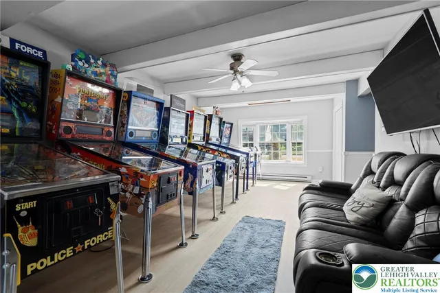 a living room with furniture a flat screen tv and a fireplace