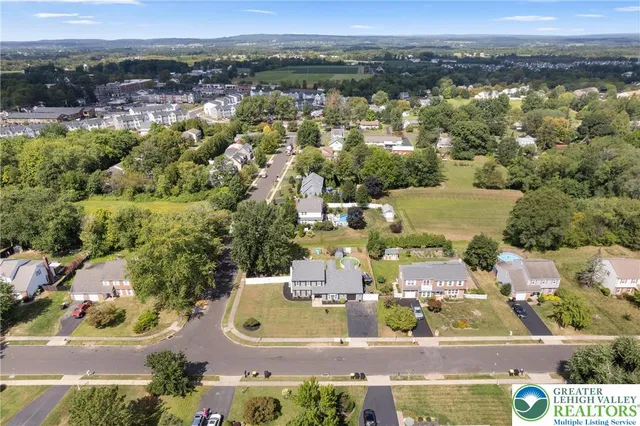 an aerial view of residential houses with outdoor space