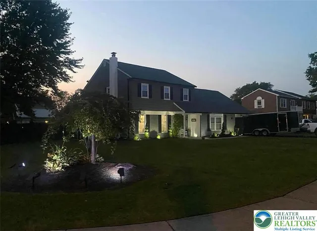 a front view of a house with a garden