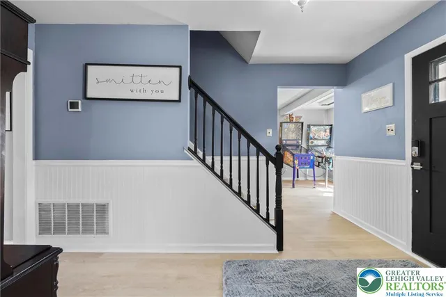 a view of a hallway with paintings on the wall