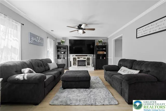 a living room with furniture and a flat screen tv