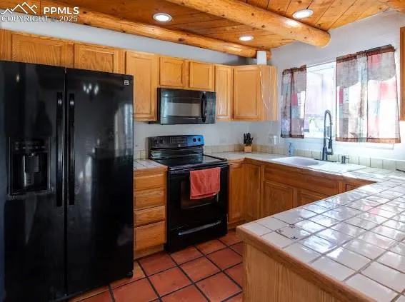 a kitchen with stainless steel appliances granite countertop a refrigerator a sink and a stove