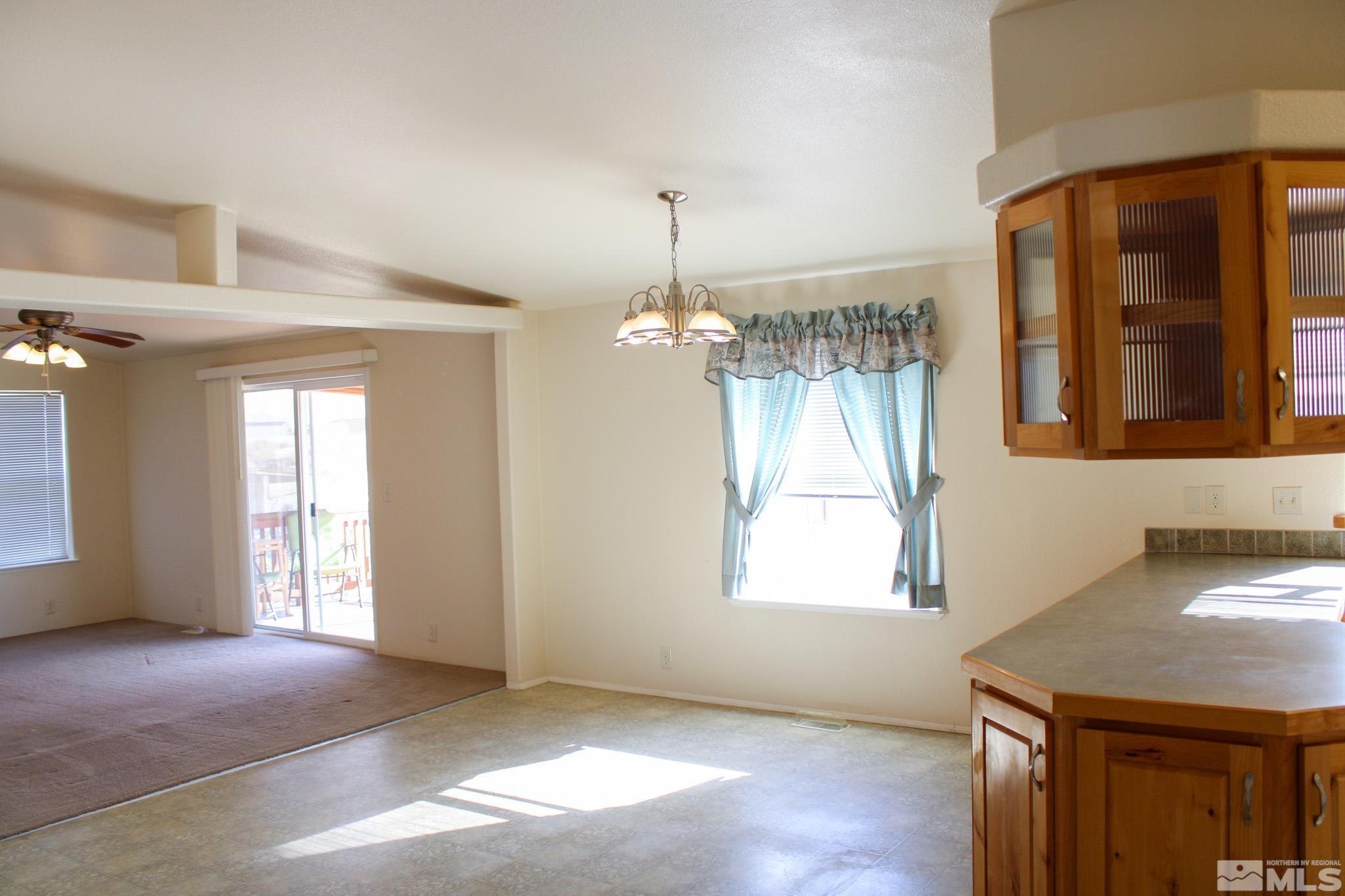 1850 Pam's Place Fallon, NV 89406 - Photo 11 of 40 wooden floor in an empty room with a window