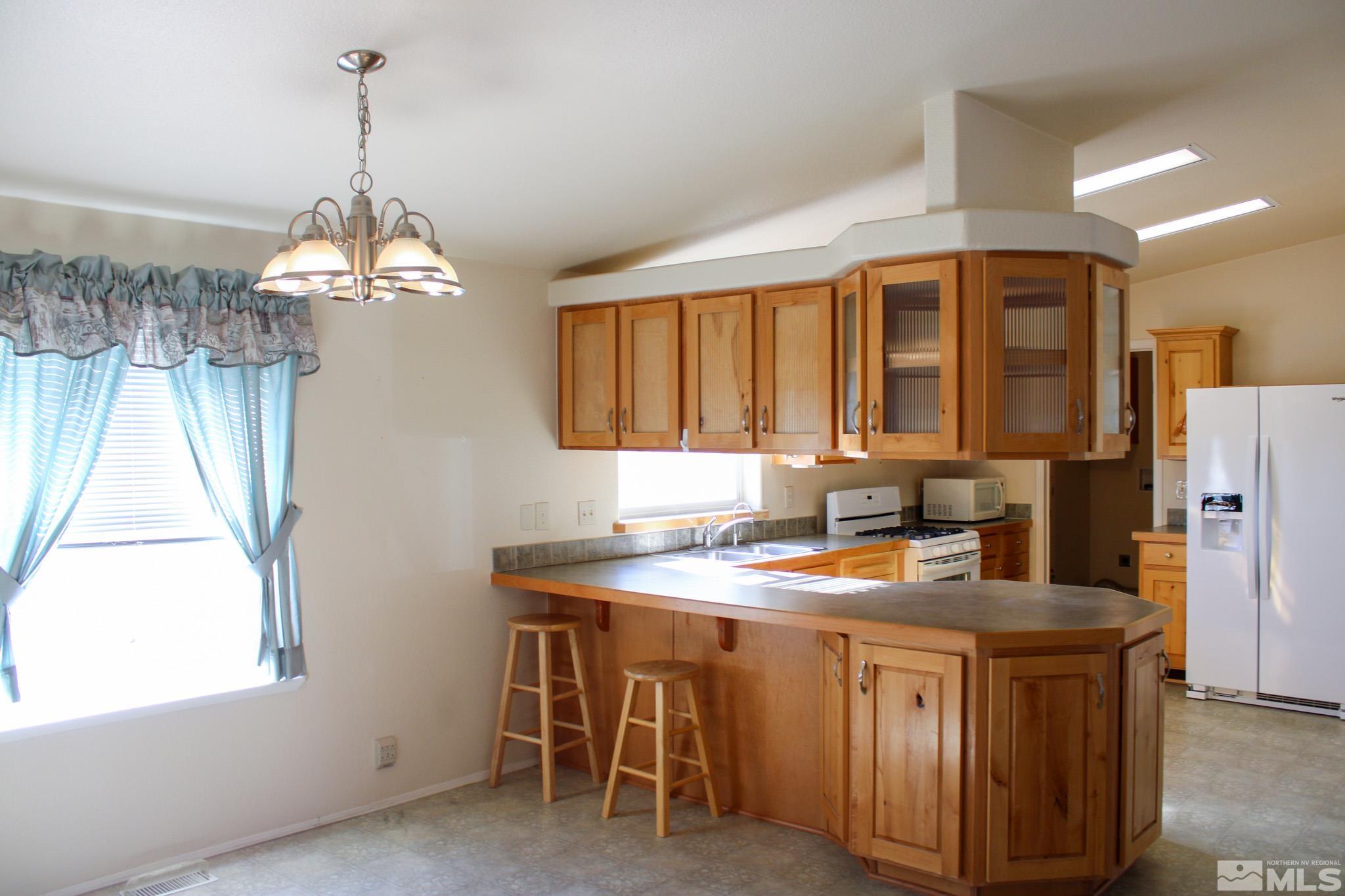 1850 Pam's Place Fallon, NV 89406 - Photo 12 of 40 a kitchen that has a lot of cabinets in it